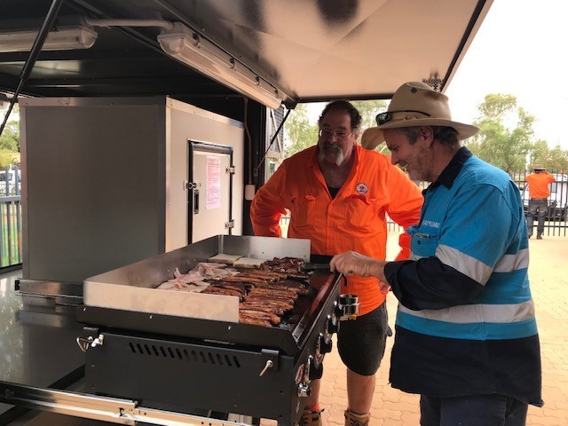 Locals of Boulia Shire enjoying a community BBQ with their new BBQ/Cold Room trailer including the Mayor Rick Britton
