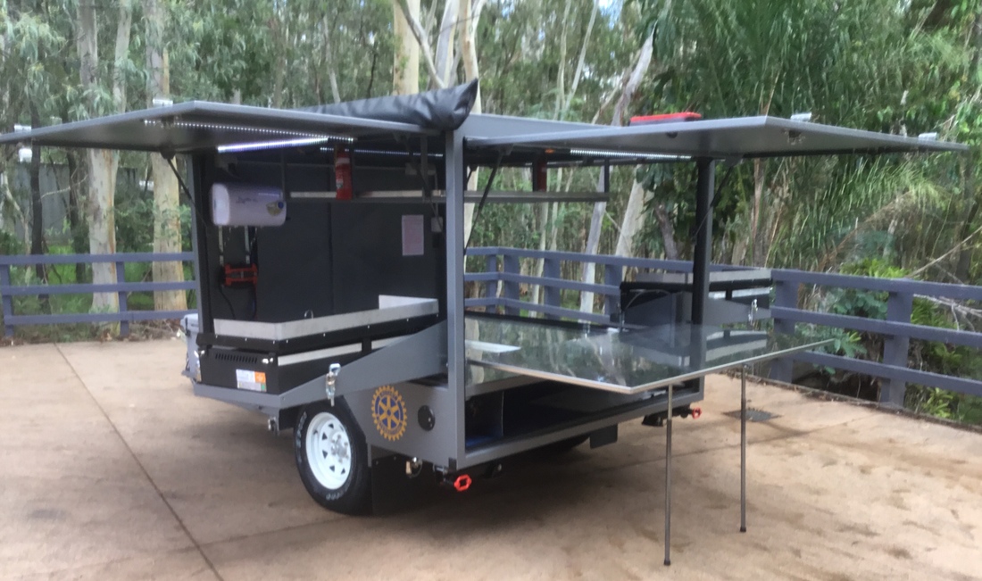 Different set up - Dual BBQs that pivot and swing out, rear door and stainless prep table, dual awnings, white and amber LED lighting and more.  This Big Bbq trailer runs on 12v and gas power!