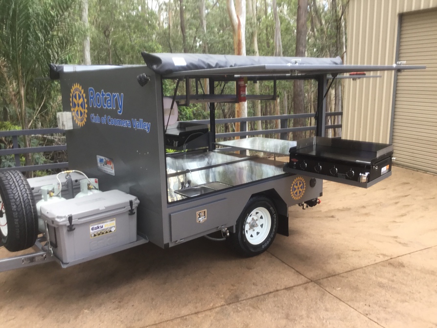 Different set up - Dual BBQs that pivot and swing out, rear door and stainless prep table, dual awnings, white and amber LED lighting and more.  This Big Bbq trailer runs on 12v and gas power!